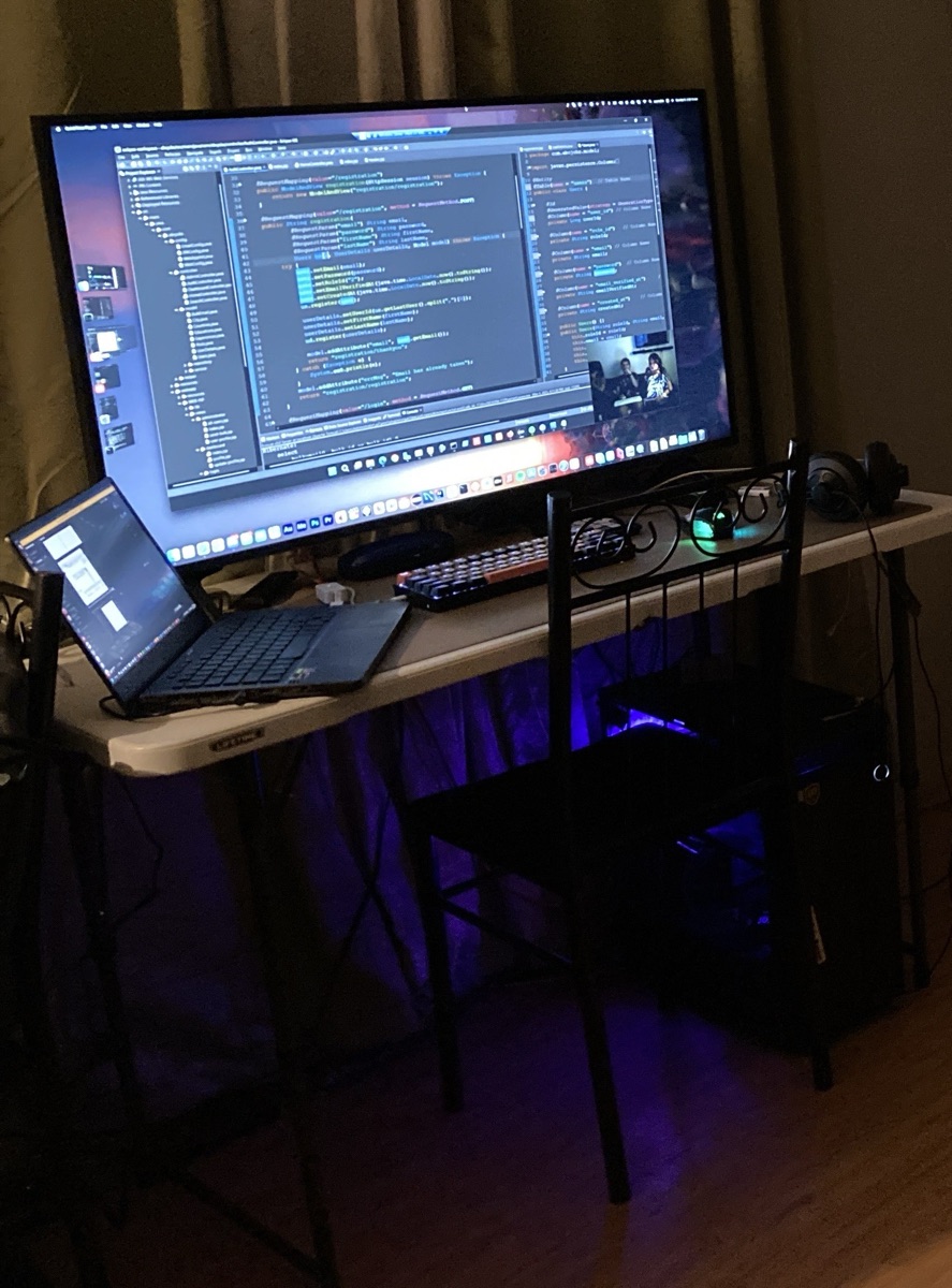 Roel's development workstation at night, Spring Boot code on the main display