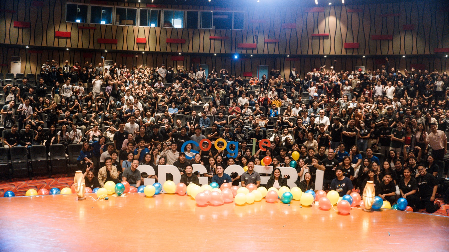 DevFest Cebu crowd — hundreds of developers in an auditorium with GDG Cebu letters on stage