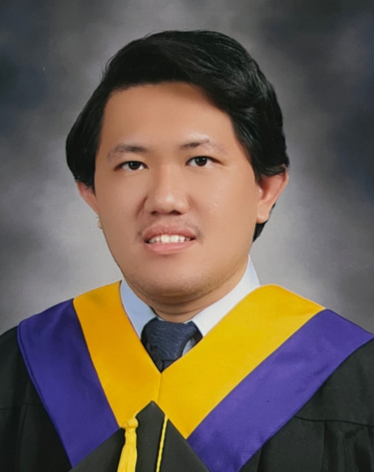 Graduation portrait of Roel Abarca in academic regalia